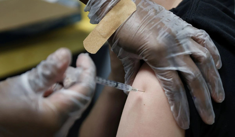 A teenager is inoculated with covid vaccine